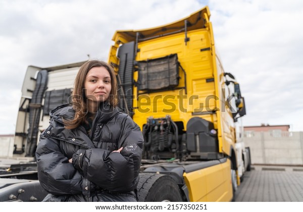 Caucasian young woman driving truck.
trucker female worker, transport industry occupation
