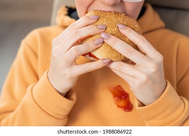 Caucasian Young Woman Eating Burger And Getting Dirty In Ketchup. Sloppy Girl