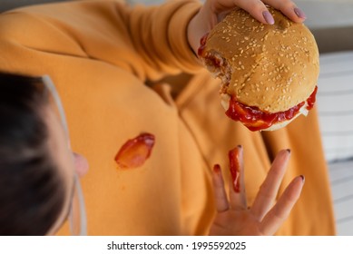 Caucasian Young Woman Eating Burger And Getting Dirty In Ketchup. Sloppy Girl