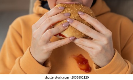 Caucasian Young Woman Eating Burger And Getting Dirty In Ketchup. Sloppy Girl