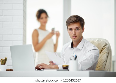 Caucasion Man And Woman Working Together In A Modern Office