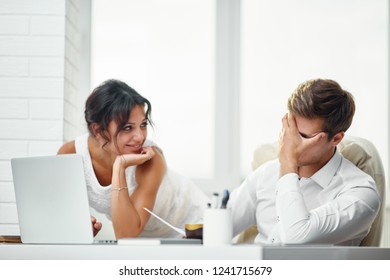 Caucasion Man And Woman Working Together In A Modern Office