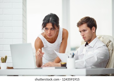 Caucasion Man And Woman Working Together In A Modern Office