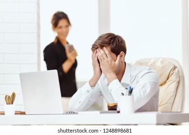 Caucasion Man And Woman Working Together In A Modern Office