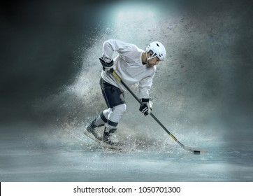 Caucassian ice hockey Player in dynamic action in a professional sport game play on the laptop in hockey under stadium lights.