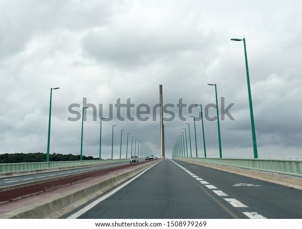 Caudebec-en-Caux, Seine-Maritime / France - 13\
August 2019: cars and trucks crossing the Brotonne bridge over the\
Seine River in\
Normandy