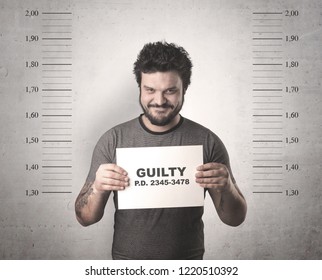 Caught guilty man with ID signs on his hand. - Shutterstock ID 1220510392