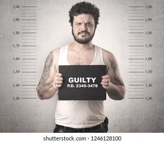Caught guilty man with ID signs on his hand. - Shutterstock ID 1246128100