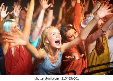 Caught up in the vibe. A huge group of fans screaming at a rock concert. - Shutterstock ID 2134656001