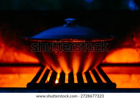 cauldron with pilaf on fire