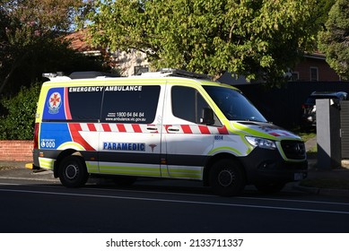 Caulfield South, Victoria, Australia - March 9 2022: Ambulance Victoria Ambulance, A Mercedes-Benz Sprinter, Parked Across The Driveway Of A Suburban Home During The Early Evening