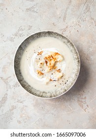 Cauliflower Cream Soup In Bowl With Fried Onion And Parmesan Cheese. Top View.