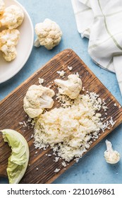 Cauliflower Rice In A Bowl On Light Stone Background With Free Text Space.