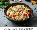 Cauliflower rice with stir-fried vegetables arranged in a bowl, vibrant colors, overhead view, professional food photography, suitable for health-focused cuisine.