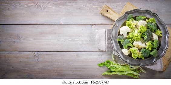 Cauliflower, savoy cabbage, romanesco broccoli and sicilian broccoli. Top view, space for text. - Powered by Shutterstock