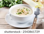 Cauliflower soup in bowl on wooden table