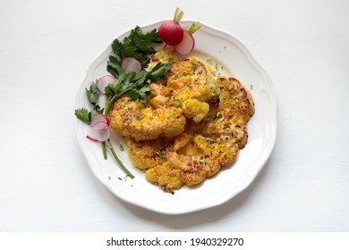 Cauliflower Steak With Herbs And Spices On Dish Isolated On White Background. Close Up View.