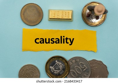 causality.The word is written on a slip of paper,on colored background. professional terms of finance, business words, economic phrases. concept of economy.