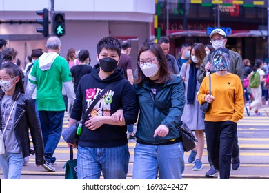 Causeway Bay/Hong Kong - Apr 4 2020: Mask-wearing Pedestrians Crossing The Street