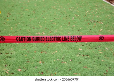 Caution Buried Electric Line Below. Caution Tape. Warning Tape. Danger Warning Tape. Electrical Lines Buried Under Ground. Electricity Hazard. Red Warning Caution Tape. 