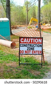 Caution - Construction Zone Sign in Front of Industrial Worksite