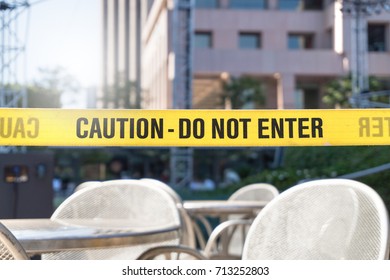 Caution, Do Not Enter Line Tape And Ribbon In City, Outdoor Terrace, Restaurant Or Building. Construction Or Crime Scene With A Warning Text. Forbidden, Prohibited Or Restricted Area.