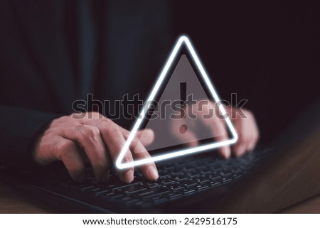 Caution failure system hacked warn alert concept. Businessman use computer laptop, triangle caution warning sign for cyber notification error, trouble maintenance. Available internet cybersecurity 