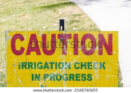 caution irrigation check in progress sign