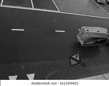 A Caution Sigh On An Airport Tarmac With A Luggage Cart