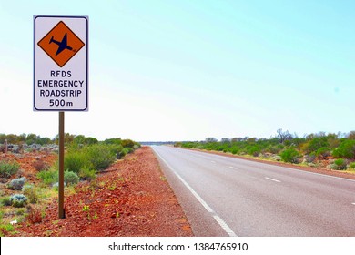 Caution Sign. Emergency Roadstrip, Airstrip For Landing Planes Of Royal Flying Doctors Service At Stuart Highway, Australian Outback. Air Transport Of Patients In Remote Areas To Hospital.