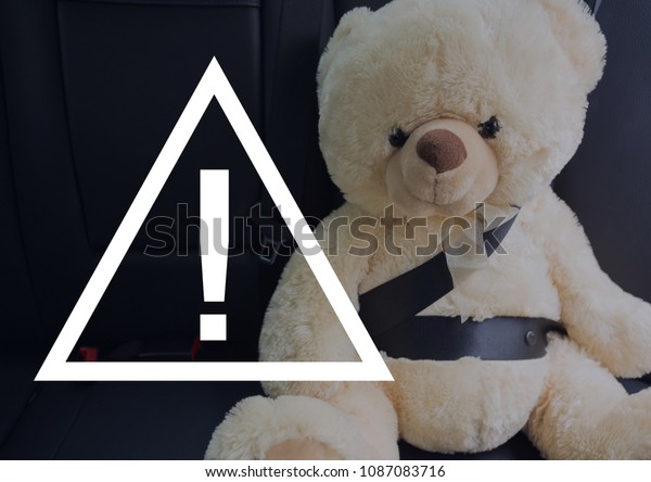 Caution sign icon
against teddy bear in the
car