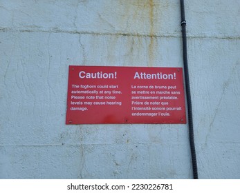A caution sign warning of a fog horn and its effects on hearing. - Shutterstock ID 2230226781