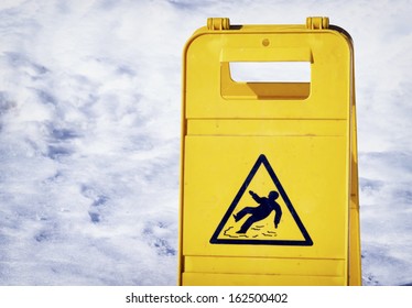 Caution Slippery Floor Sign At An Entrance In Winter