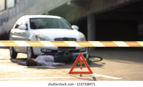 Caution Tape Front Of Traffic Collision Scene, Unconscious Bicyclist Hit By Car