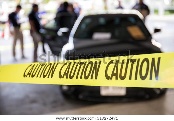 caution tape or police line protect vehicle in\
crime scene investigation training in academy with blurred law\
enforcement background