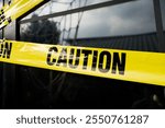 Caution yellow tape. Do not enter. Yellow caution tape on the home at daytime. Crime scene