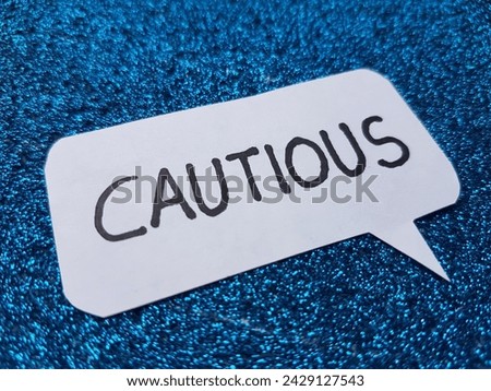 Cautious writting on blue background.