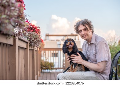 A Cavalier King Charles Spaniel Serving As A Therapy Dog Spends Time With A Mature Man.