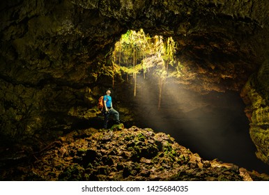 Cave in the Azores with backpacker