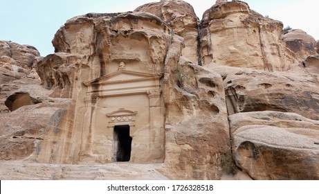 Cave Carved In Red Mountain Rock. Sedimentary Sandstone Rock Formation.