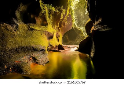 A cave filled with water. Rainforest cave in water. Cave in rainforest. Cave pass