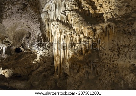 Cave flowstone hangs downward, create curtain-like sheaves along ledges, better known as draperies.
Carlsbad Caverns National Park, New Mexico, USA.