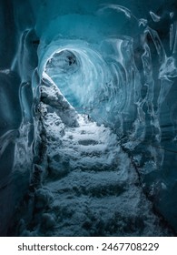 The cave at Katla Ice Cave features mesmerizing blue ice, intricate formations, and a surreal atmosphere created by the interplay of light and ice.