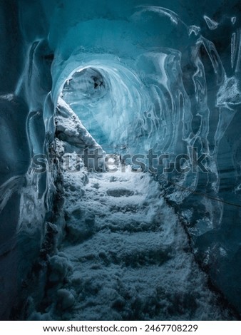 The cave at Katla Ice Cave features mesmerizing blue ice, intricate formations, and a surreal atmosphere created by the interplay of light and ice.