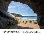 Cave on the sandy beach in Penbryn, Cardigan Bay, Wales. Taken on a sunny day when the beach was empty.