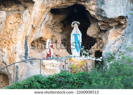Cave of Our Lady of Lourdes (Cova de Lourdes), outdoor rocky chapel with a wooden sculpture of the Virgin Mary and of Saint Bernadette. Santa Eugenia, Majorca, Spain.