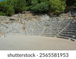 The Cavea seating area of the 3rd century Roman Amphitheatre in Butrint Archaeological Park, within Butrint National Park, southern Albania. A UNESCO World Heritage Site. 