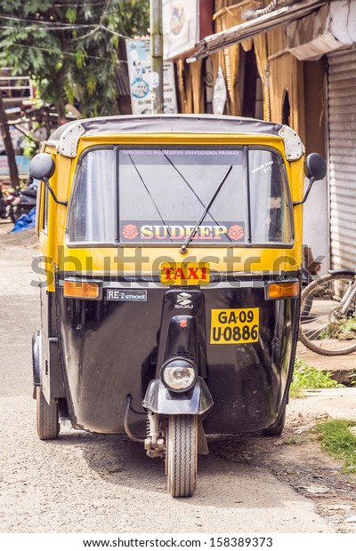 CAVELOSSIM BEACH, GOA, INDIA -\
SEPTEMBER 22, 2013: Auto rickshaw (tuk-tuk) taxis on a road. Auto\
rickshaws running on natural gas in an effort to reduce\
pollution.