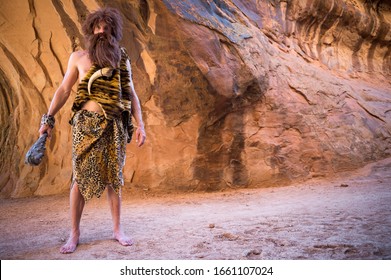 Caveman Standing Outdoors Holding His Club In An Empty Cave 