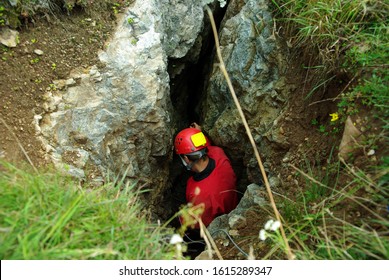 Caver Descends In A Cave. Spelunking Is An Extreme Sport